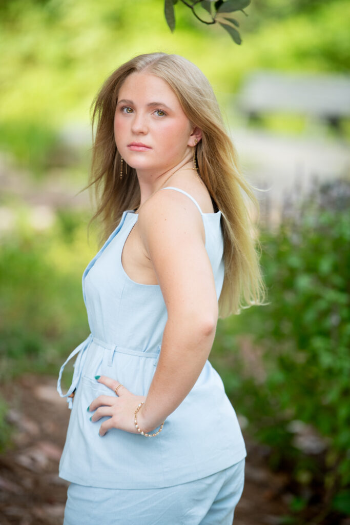 Senior girl wearing blue in Strawberry Patch Park in Madison, MS