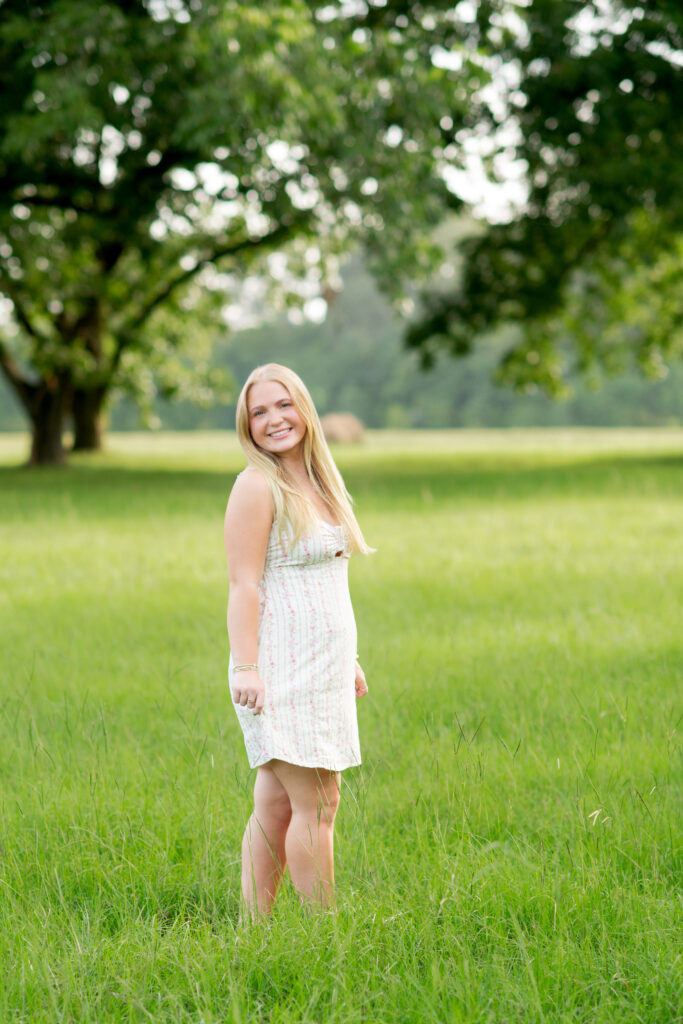 Senior girl walking in pecan grove in Madison, MS