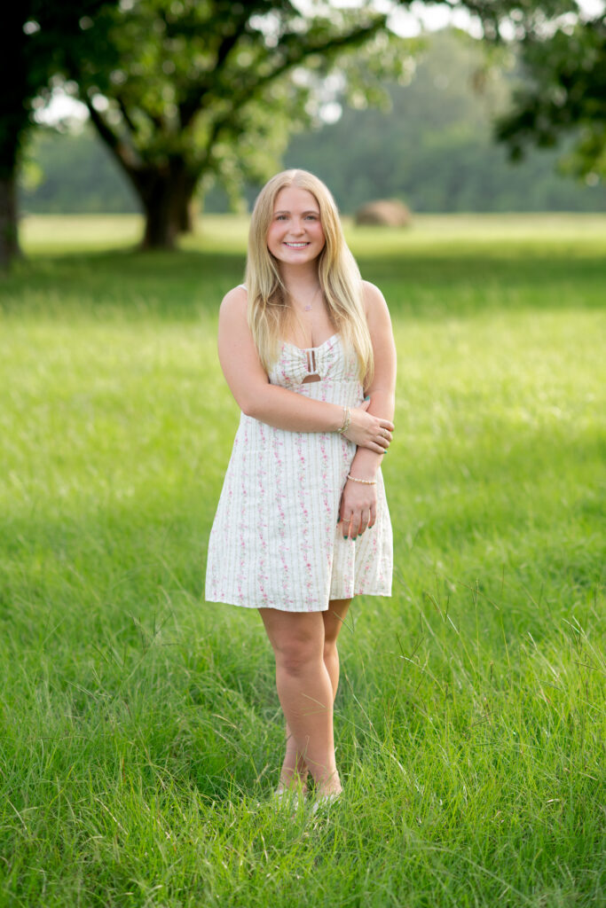 Senior girl standing in pecan grove in Madison, MS